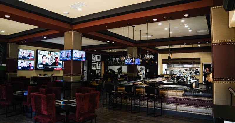 Restaurant bar seating area with TV screens